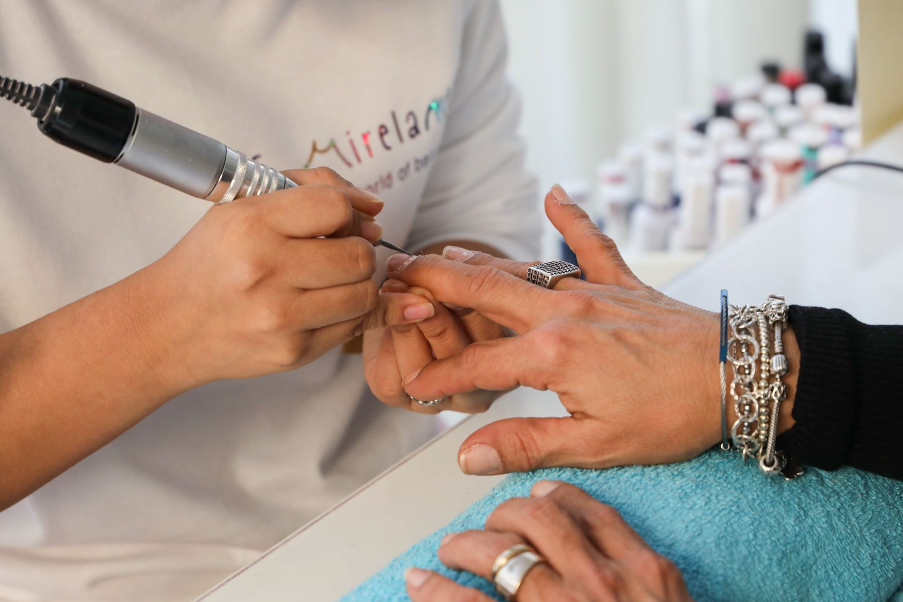 Nail technician filing a client's nails